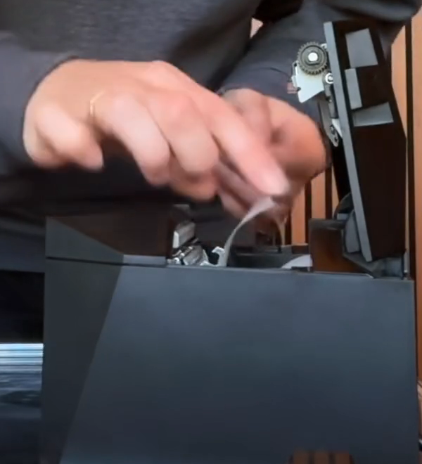 Loading the thermal paper roll into the open printer